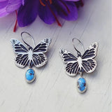 Boucles d'oreilles vintage en argent avec papillon et pierre bleue