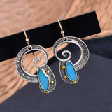 Boucles d'oreilles vintage en spirale avec pierre bleue
