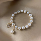 Bracelet avec pendentif en or, perle blanche et tournesol