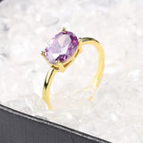 Bague ovale en or avec pierre précieuse violette et bande polie
