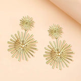 Boucles d'oreilles vintage en or avec motif soleil rayonnant