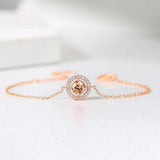 Bracelet classique en or rose avec gemme orange ronde et bordure étincelante