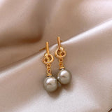 Boucles d'oreilles créoles en or et perles grises