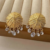 Boucles d'oreilles classiques en or avec disque texturé et pendentif en cristal