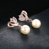 Boucles d'oreilles pendantes vintage en or rose et perles