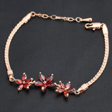 Bracelet rétro en or rose avec trois fleurs en cristal rouge