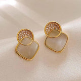 Boucles d'oreilles pendantes vintage en or rond avec diamants croisés