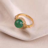 Bague ajustable vintage en or avec pierre précieuse verte et cristal brillant