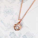 Collier vintage avec pendentif torsadé en or rose et pierre précieuse brillante