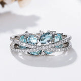 Bague croisée en argent avec pierre précieuse bleue