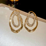 Boucles d'oreilles vintage en or avec cristaux étincelants et monture ovale