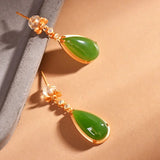 Boucles d'oreilles pendantes classiques en or et cristal vert incrusté de pierres précieuses