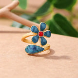 Bague ajustable rétro en or avec fleur en émail bleu et pierre rouge