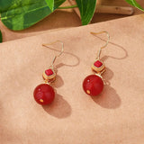 Boucles d'oreilles pendantes vintage en or et pierres précieuses rouges rondes