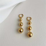 Boucles d'oreilles pendantes à trois boules brillantes en or