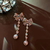 Boucles d'oreilles vintage en or avec cristal, nœud et perle