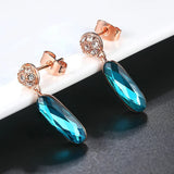 Boucles d'oreilles pendantes vintage en or rose avec pendentif en cristal bleu sarcelle