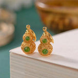Boucles d'oreilles pendantes vintage en or et pierres précieuses vertes