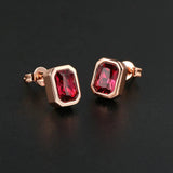 Boucles d'oreilles vintage en or rose avec cristaux rouge foncé