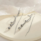 Boucles d'oreilles longues vintage en argent avec boules