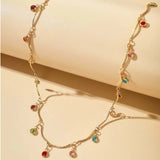 Collier en or avec pierres aux couleurs vives et chaîne torsadée