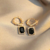 Boucles d'oreilles pendantes en or et zircone noire