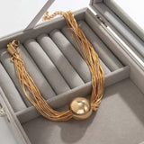 Collier vintage à plusieurs rangs avec pendentif boule en or