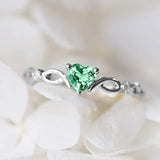 Bague classique en argent avec pierre précieuse verte en forme de cœur et motif tourbillon