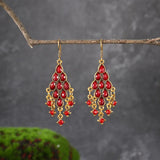 Boucles d'oreilles pendantes vintage en or et cristal rouge