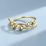 Bague vintage ajustable à double boucle et perles dorées