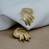 Boucles d'oreilles vintage en spirale dorée avec plumes