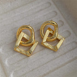 Boucles d'oreilles rétro en or avec nœuds entrelacés