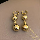 Boucles d'oreilles classiques en forme de goutte et ornées d'une boule dorées
