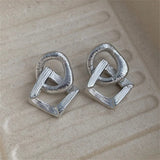 Boucles d'oreilles vintage en argent avec nœud géométrique