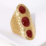 Bague vintage ajustable en or et trois pierres rouges
