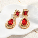 Boucles d'oreilles pendantes vintage en or avec pierres précieuses rouges