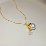 Collier vintage avec pendentif en or et perle et breloque étoile