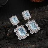 Boucles d'oreilles vintage avec gemme bleue et monture en cristal
