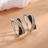 Boucles d'oreilles créoles vintage croisées noires et argentées