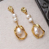 Boucles d'oreilles pendantes ovales en or et perles