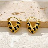 Boucles d'oreilles en forme de cœur dorées et noires à pois