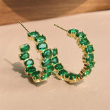 Boucles d'oreilles créoles en or et pierres précieuses vertes